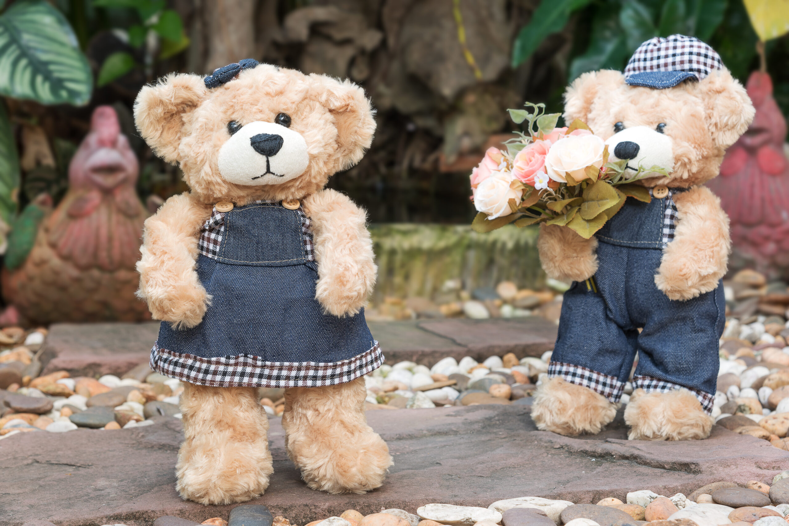 two teddy bears with roses on garden background, concept love